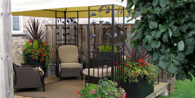 Photo of gazebo surrounded by colorful plants